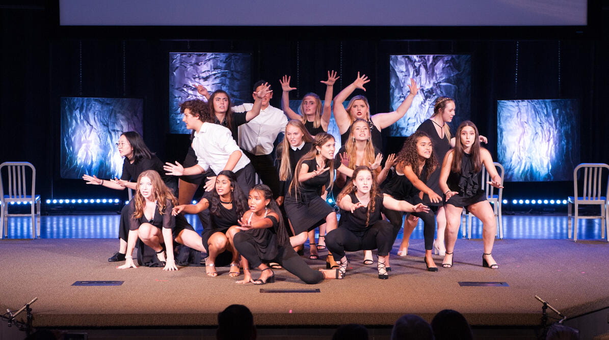 Students performing on a stage