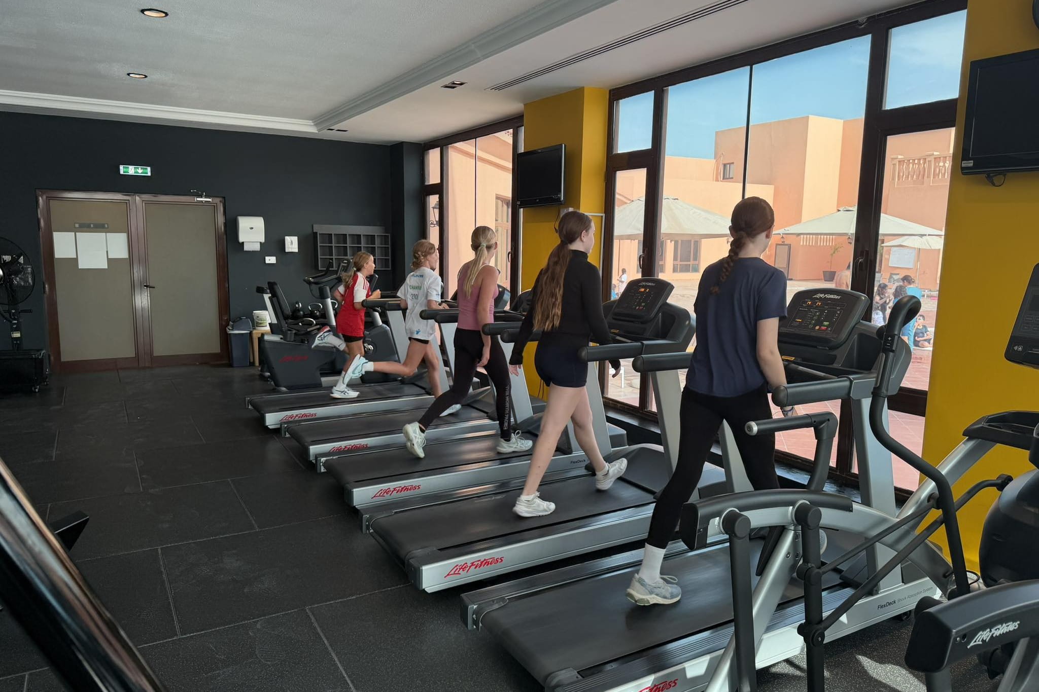 Students running in the gym for the “Around the World in 30 Days” challenge