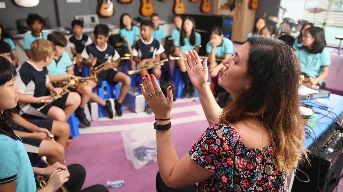 Teacher leading a music lesson