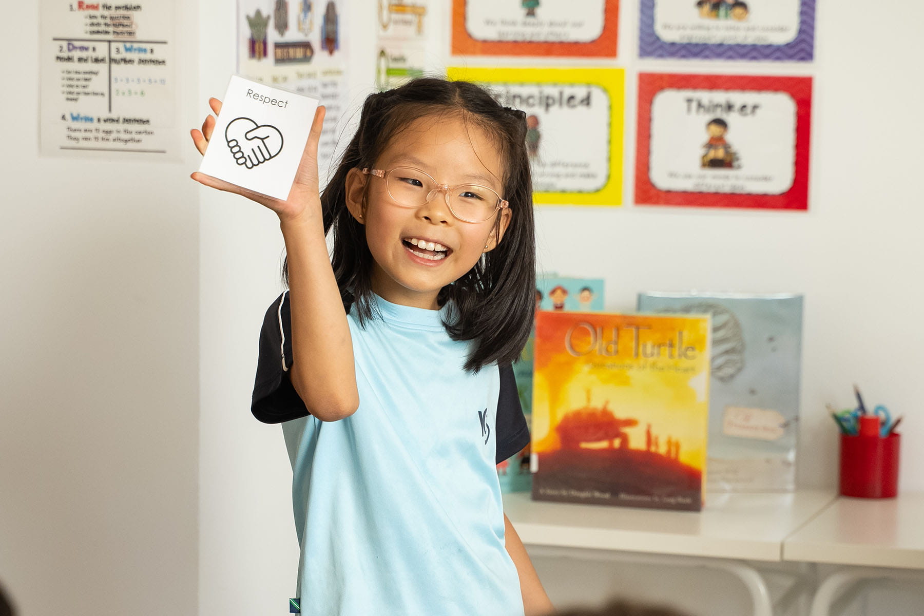 Student sharing a classroom activity focused on respect and emotional learning at ICS.