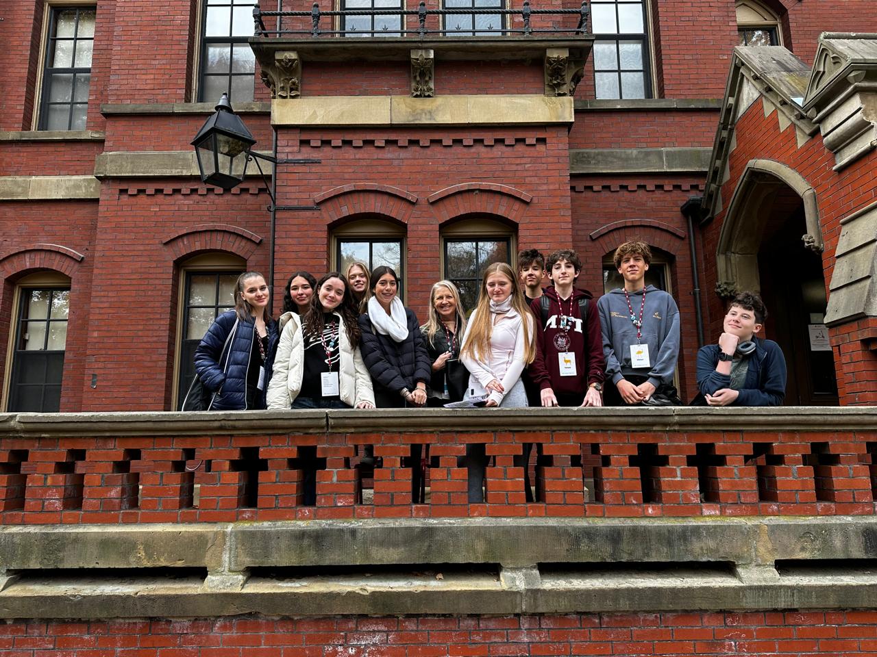 A group of eleven students from Nord Anglia schools are in front of a MIT building in Massachusetts Institute of Technology