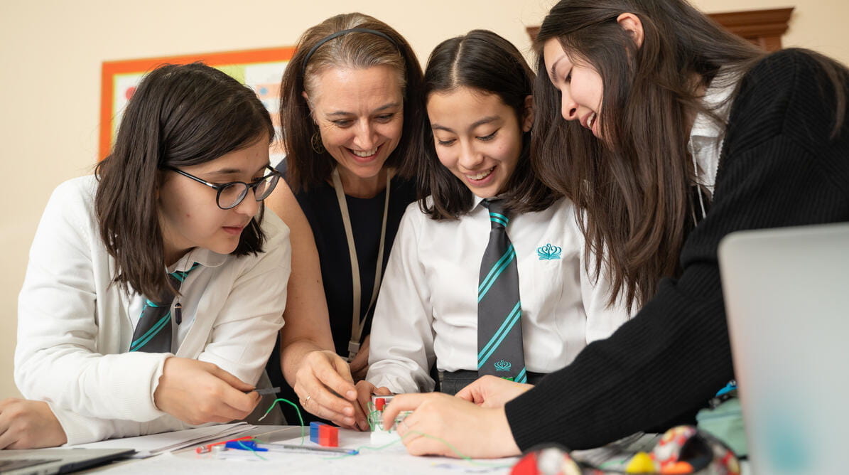 Student working together with a teacher on a project