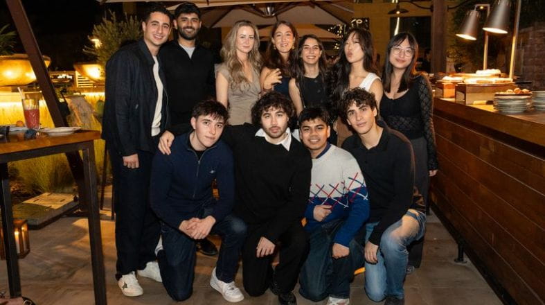 A group photo of NAS Dubai alumni at an event