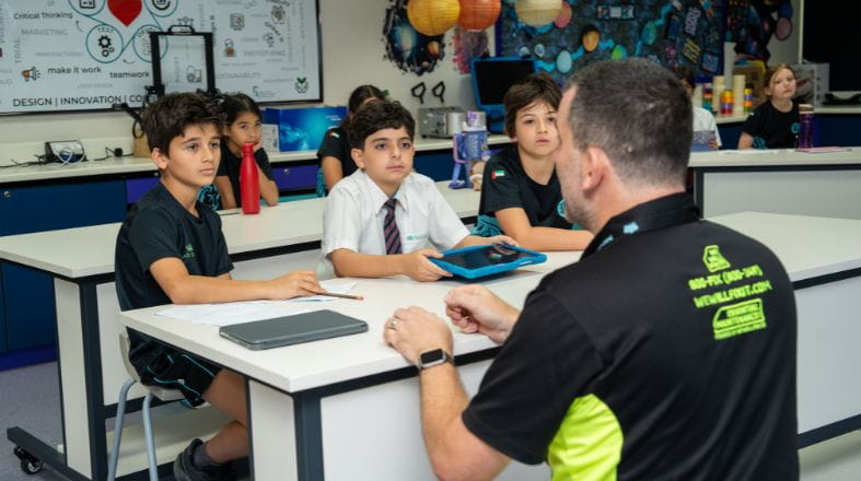 NAS Dubai Primary students taking part in a hands-on STEAM lesson with their teacher.