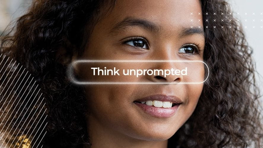 Female student smiling with prompt text reading 'Think Unprompted'