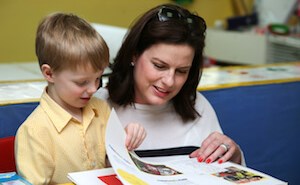 Teacher and boy reading