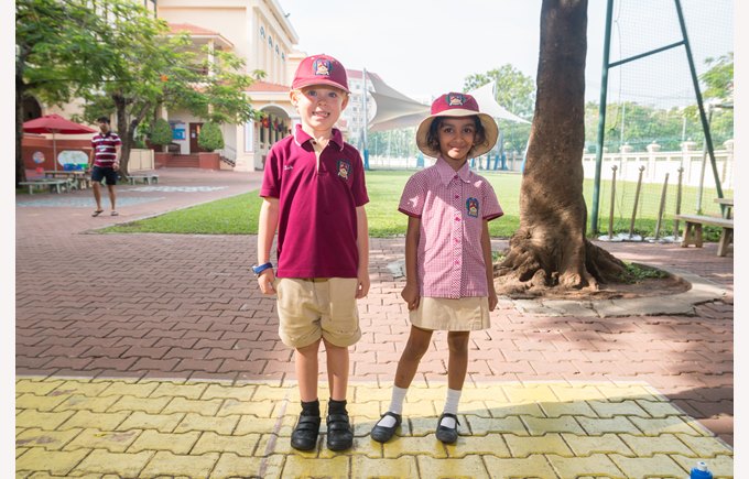 Two Primary students wearing full uniform