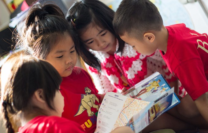 Foundation Children reading a book together at British International School, HCMC