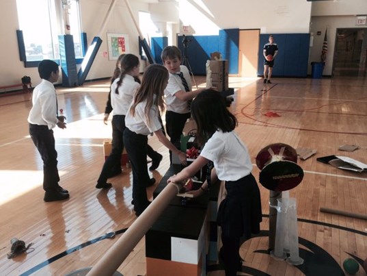 Global Campus students making Rube Goldberg machines.