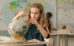 girl making paper globe