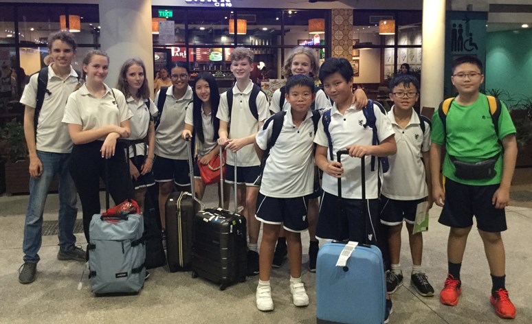 Students with their suitcases traveling to Cambodia
