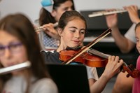 Young female student playing violin