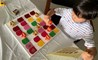 An early years students sorts objects during a virtual school lesson