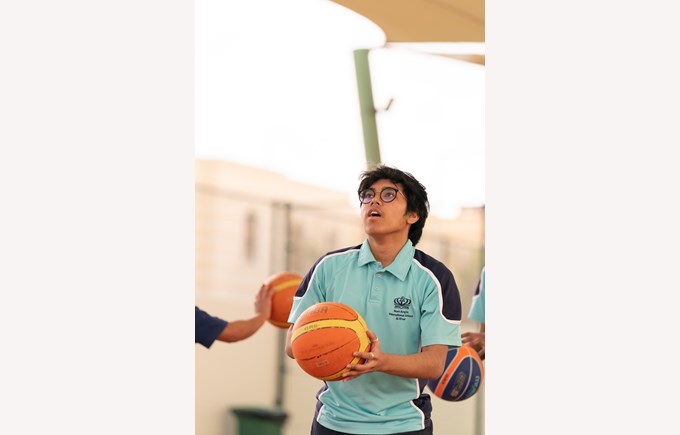 Secondary boy playing basketball