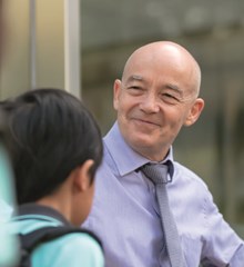 School Principal greets students