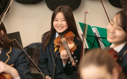 A girl playing on the instrument.