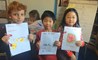 ESL students in Primary School show off their work 