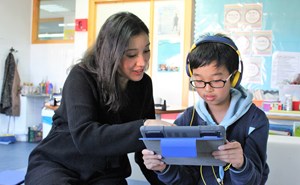 ICS EAL department iPad teacher with student headphones