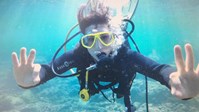 woman snorkeling underwater goggles