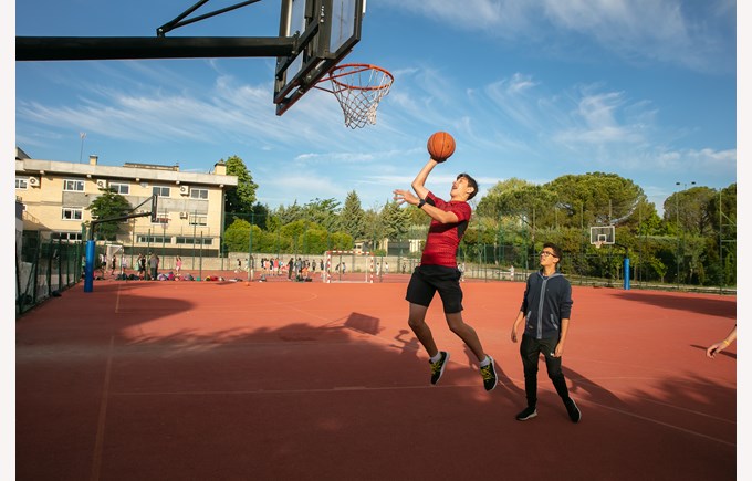 Boys playing ball on a basketball court