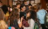 Teenagers chatting between classes in a school hallway