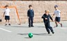 A young boy plays soccer at recess
