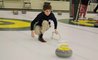 A middle school student plays curling