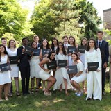 Graduates pose with their diplomas