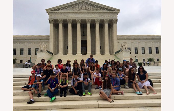 A group of students stand in front of the Library of Congress