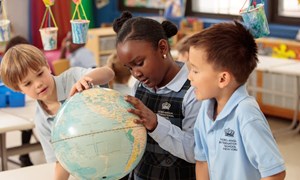 Children looking at globe
