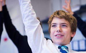 BISW Private British International School of Washington in DC Engaged grade student raising hand in classroom learning