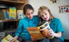 BISW Private British International School of Washington in DC Smart primary students reading together in library