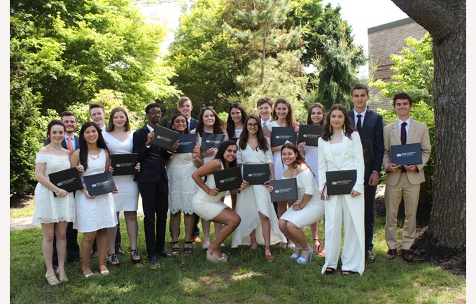 2017 Graduates pose with their diplomas