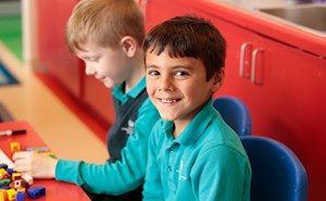 Boy Smiling in Classroom