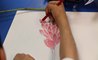 A student draws a picture of a flower