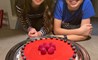 Shirin and Sam showing off their cake made with fruits, nuts, and coconut!