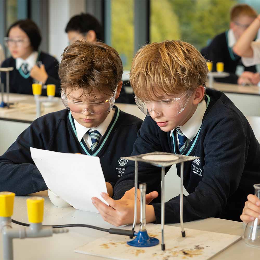two students study in chemistry lab
